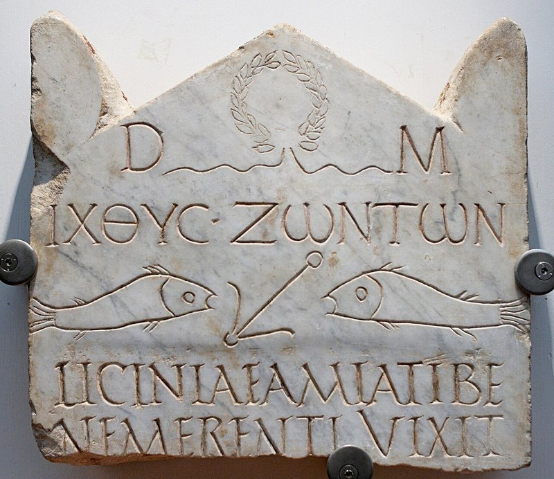 Lápide de mármore com a inscrição ΙΧΘΥΣ ΖΩΝΤΩΝ, dois peixes voltados para uma âncora e, embaixo, o nome de Licínia Amias em latim